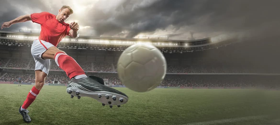 Athlete kicking soccer ball